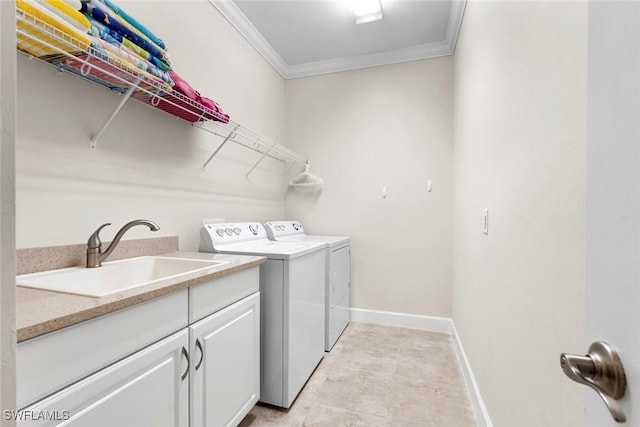 3260 Miyagi Ln, Naples, FL 34114 - laundry room with crown molding, baseboards, separate washer and dryer, a sink, and cabinet space