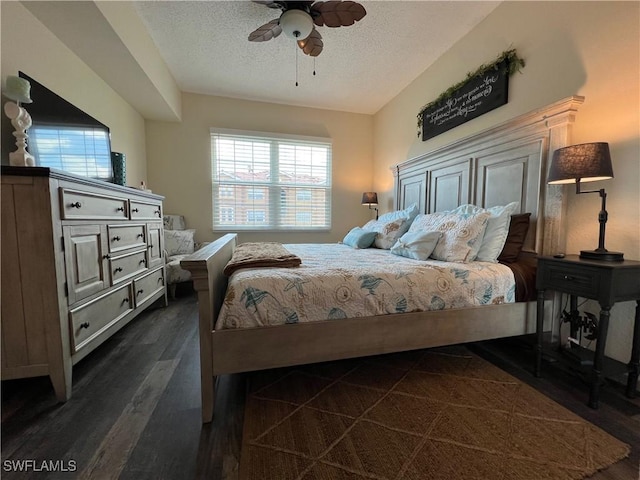 15585 Ocean Walk Cir Unit 216, Fort Myers, FL 33908 - bedroom featuring multiple windows, a textured ceiling, dark wood-style floors, and ceiling fan