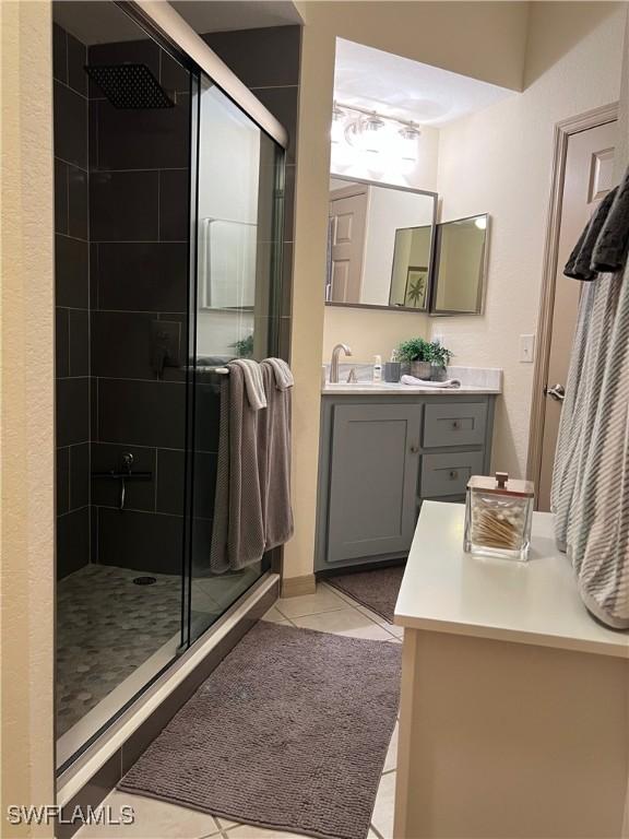 15585 Ocean Walk Cir Unit 216, Fort Myers, FL 33908 - full bathroom featuring a shower stall, tile patterned flooring, and vanity