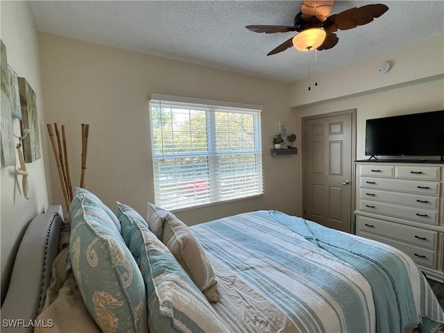 15585 Ocean Walk Cir Unit 216, Fort Myers, FL 33908 - bedroom featuring a textured ceiling and ceiling fan