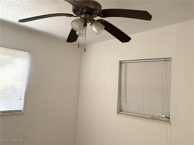 1308 Brookhill Dr, Fort Myers, FL 33916 - details featuring a textured ceiling, ceiling fan, and a textured wall