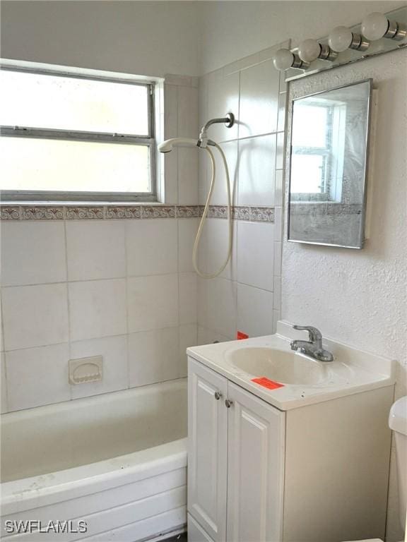 1308 Brookhill Dr, Fort Myers, FL 33916 - bathroom featuring a textured wall, shower / bathing tub combination, toilet, and vanity