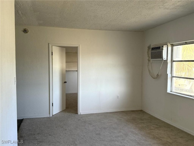 1308 Brookhill Dr, Fort Myers, FL 33916 - unfurnished bedroom with a spacious closet, carpet floors, an AC wall unit, and a textured ceiling