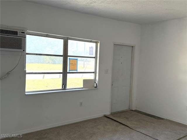 1308 Brookhill Dr, Fort Myers, FL 33916 - carpeted empty room with a wall unit AC, baseboards, and a textured ceiling