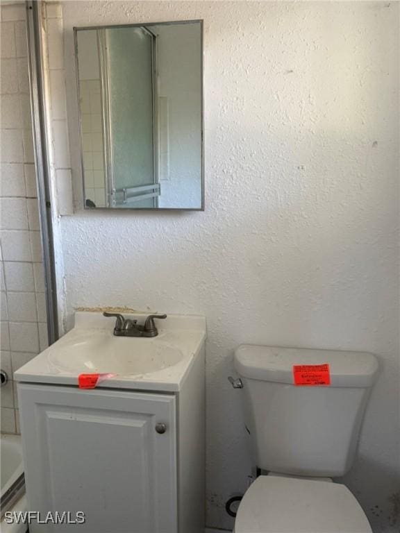 1308 Brookhill Dr, Fort Myers, FL 33916 - full bath with toilet, vanity, and a textured wall