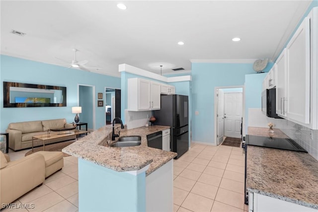kitchen featuring light tile patterned floors, a sink, black appliances, a peninsula, and open floor plan