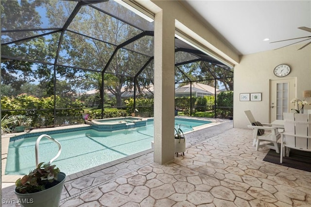 view of pool featuring ceiling fan, a lanai, a pool with connected hot tub, and a patio