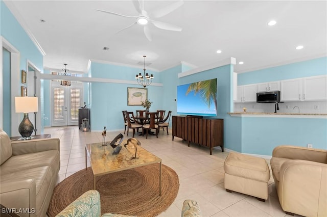 living area featuring crown molding, ceiling fan with notable chandelier, light tile patterned flooring, french doors, and recessed lighting