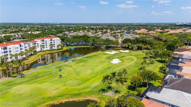 drone / aerial view featuring a residential view, a water view, and golf course view
