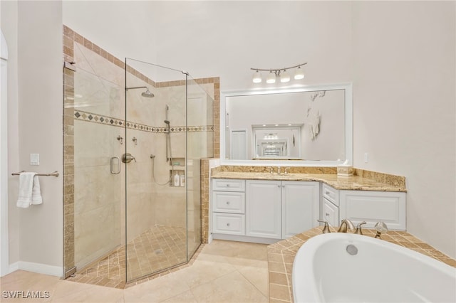 bathroom with tile patterned floors, a shower stall, a garden tub, and vanity