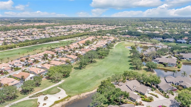 aerial view featuring golf course view, a water view, and a residential view