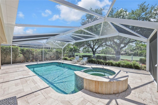 view of pool with a patio, glass enclosure, a fenced backyard, and a pool with connected hot tub