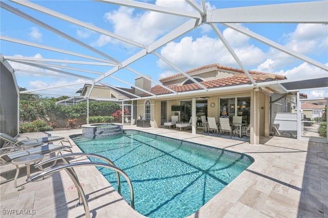 view of pool with a patio, a pool with connected hot tub, and a lanai