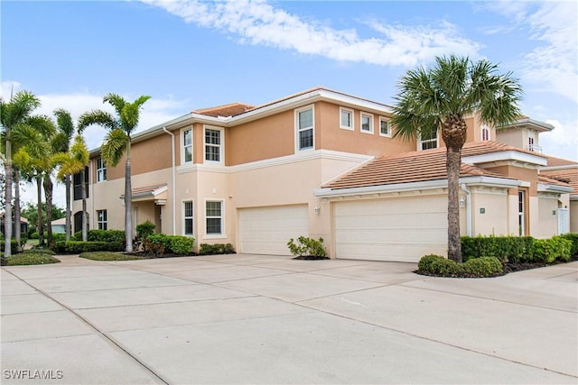 10644 Pelican Preserve Blvd # 101, Fort Myers, FL 33913 - view of property with a tile roof, stucco siding, a garage, and concrete driveway