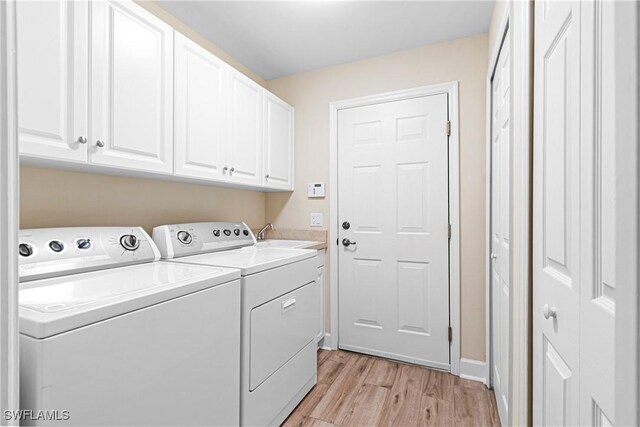 10644 Pelican Preserve Blvd # 101, Fort Myers, FL 33913 - laundry area with washing machine and clothes dryer, cabinet space, light wood-style flooring, and a sink