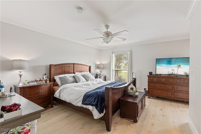 bedroom featuring light wood-type flooring, ornamental molding, and a ceiling fan