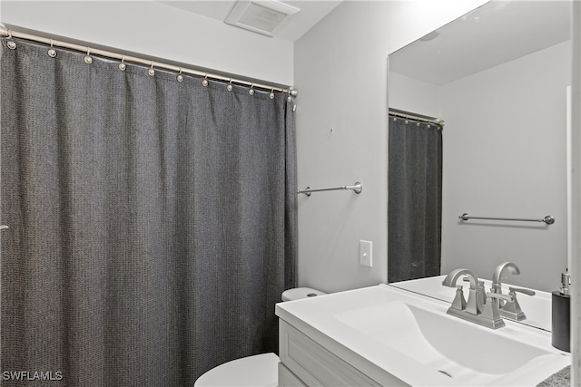 full bathroom with visible vents, toilet, and vanity