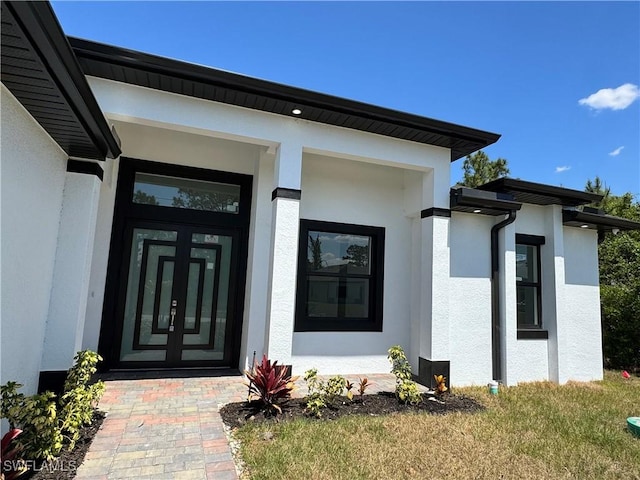 1173 Ebers St E, Lehigh Acres, FL 33974 - view of exterior entry featuring stucco siding