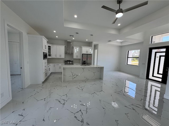 1173 Ebers St E, Lehigh Acres, FL 33974 - kitchen with stainless steel appliances, open floor plan, wall chimney exhaust hood, and a raised ceiling