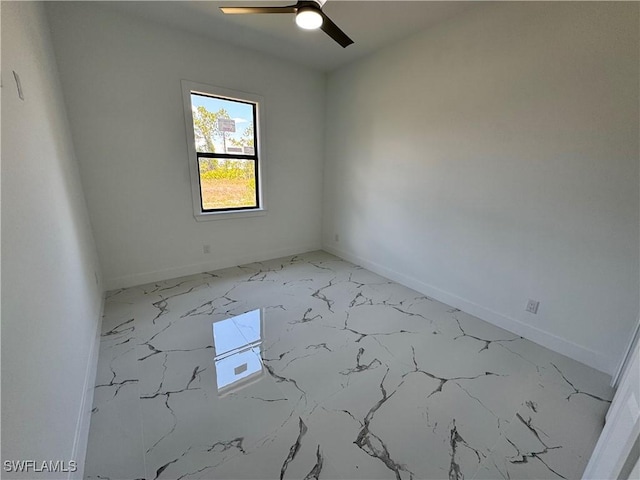1173 Ebers St E, Lehigh Acres, FL 33974 - unfurnished room featuring marble finish floor, baseboards, and a ceiling fan