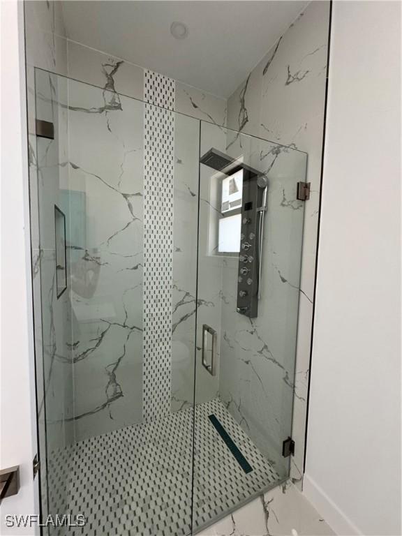 1173 Ebers St E, Lehigh Acres, FL 33974 - full bathroom with a marble finish shower and marble finish floor