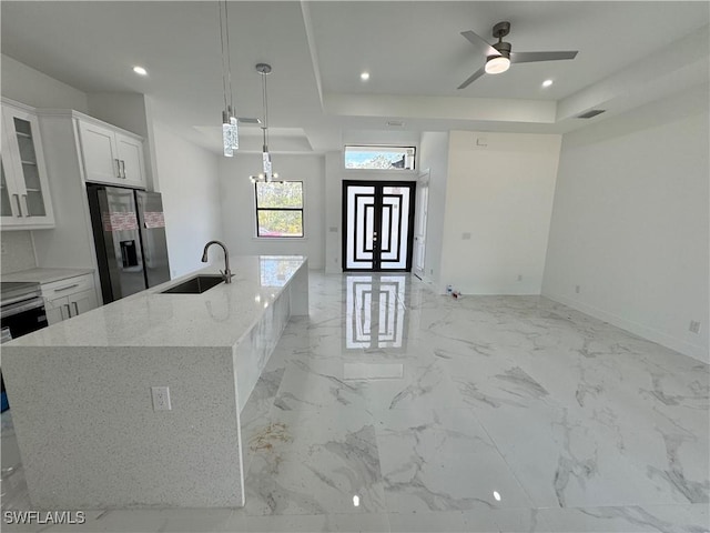 1173 Ebers St E, Lehigh Acres, FL 33974 - kitchen with stainless steel fridge with ice dispenser, recessed lighting, open floor plan, glass insert cabinets, and a sink
