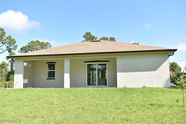 2515 45th St W, Lehigh Acres, FL 33971 - back of property featuring stucco siding, a lawn, and roof with shingles