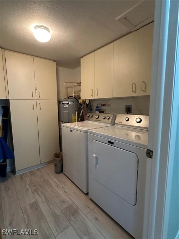 4244 SE 20th Pl Unit 218, Cape Coral, FL 33904 - washroom with a textured ceiling, attic access, water heater, cabinet space, and separate washer and dryer
