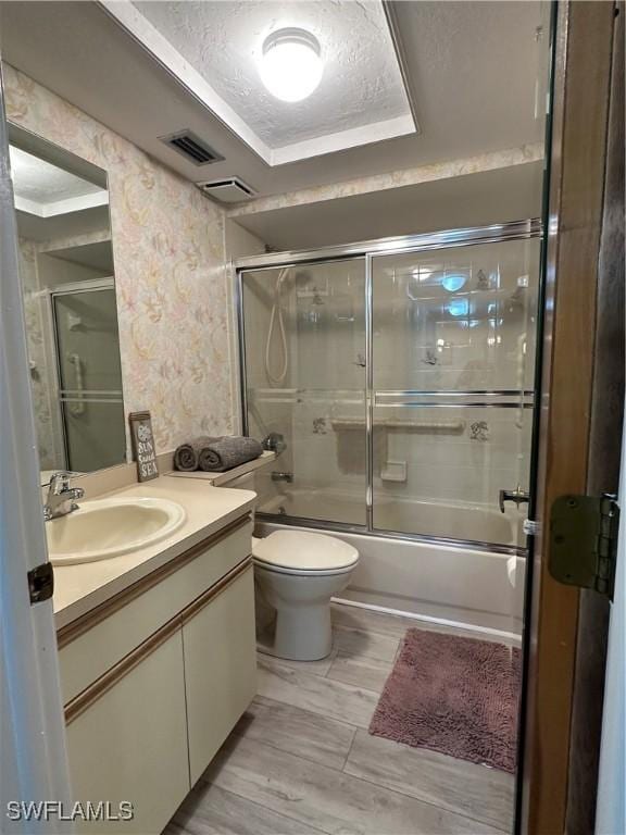 4244 SE 20th Pl Unit 218, Cape Coral, FL 33904 - bathroom featuring toilet, vanity, a textured ceiling, bath / shower combo with glass door, and visible vents