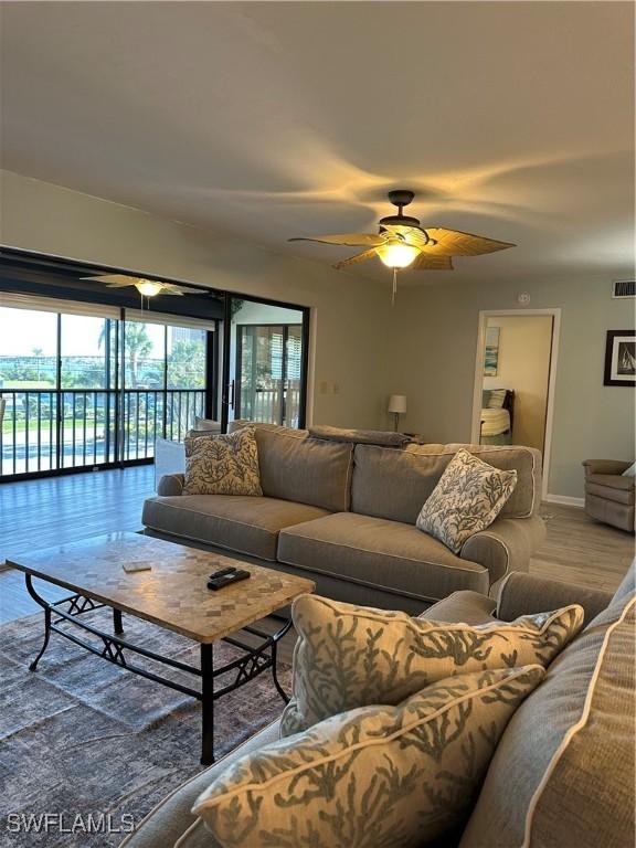 4244 SE 20th Pl Unit 218, Cape Coral, FL 33904 - living area featuring baseboards, visible vents, wood finished floors, and a ceiling fan