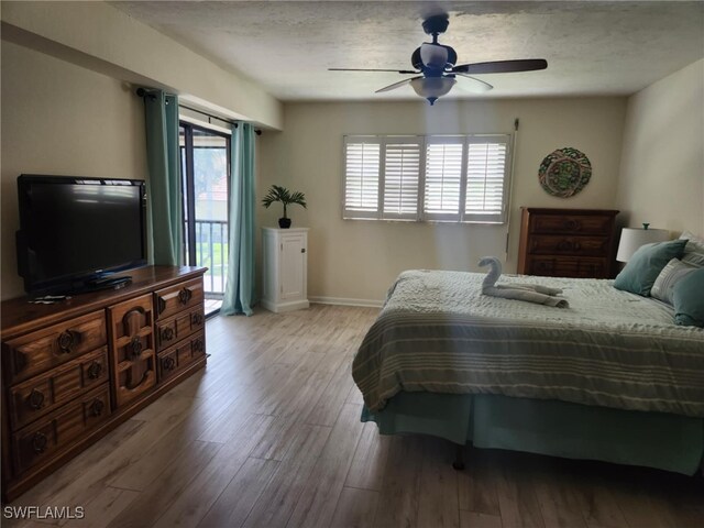 4244 SE 20th Pl Unit 218, Cape Coral, FL 33904 - bedroom featuring a textured ceiling, access to outside, baseboards, light wood-style floors, and ceiling fan