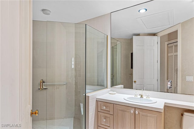 bathroom with vanity, toilet, and a shower stall