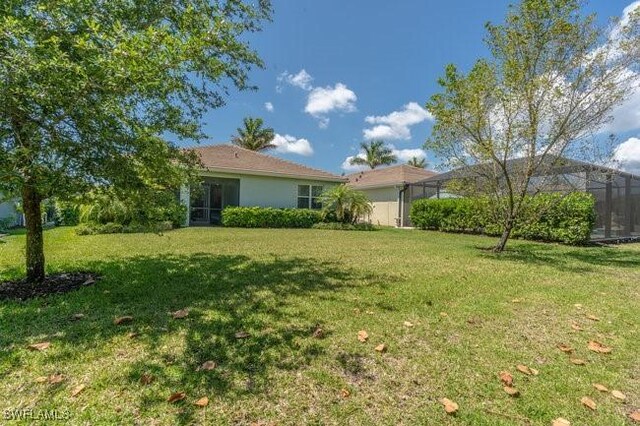 14566 Tropical Dr, Naples, FL 34114 - view of yard with glass enclosure