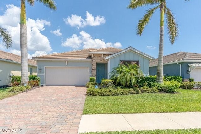 14566 Tropical Dr, Naples, FL 34114 - view of front facade featuring a garage, decorative driveway, and a front lawn