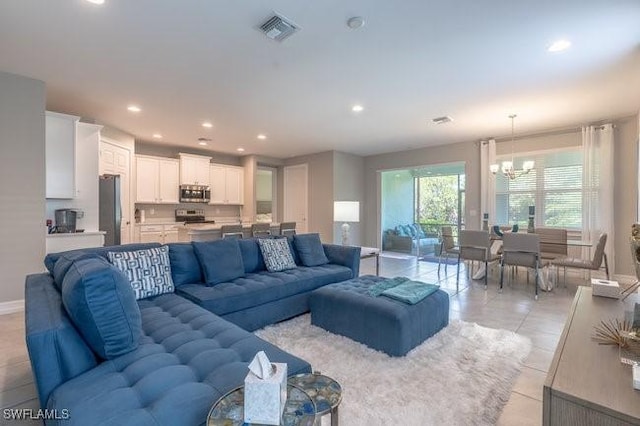14566 Tropical Dr, Naples, FL 34114 - living room featuring visible vents, recessed lighting, an inviting chandelier, and light tile patterned floors