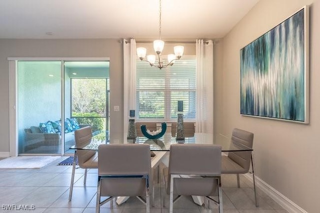 14566 Tropical Dr, Naples, FL 34114 - dining space with a chandelier, tile patterned flooring, and baseboards