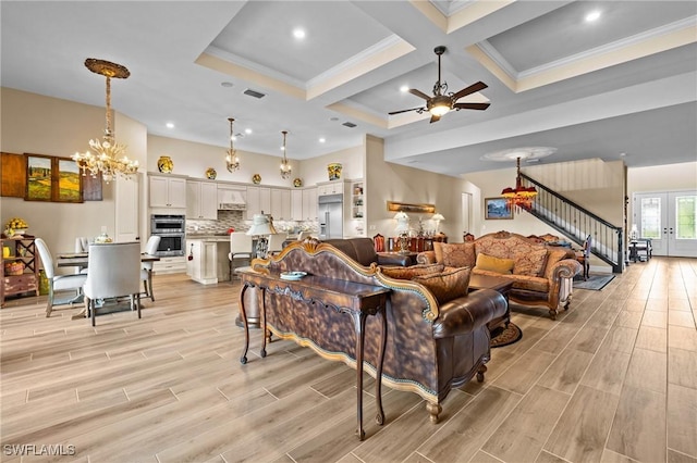 9435 Night Heron Ln, Naples, FL 34120 - living area featuring visible vents, ceiling fan with notable chandelier, stairs, and wood tiled floor