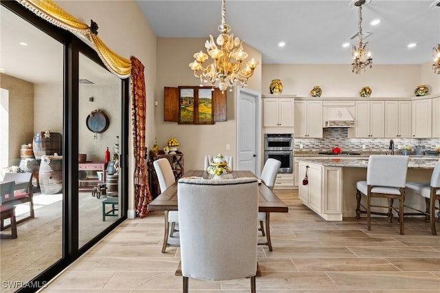 9435 Night Heron Ln, Naples, FL 34120 - dining area featuring visible vents, wood tiled floor, recessed lighting, and a notable chandelier