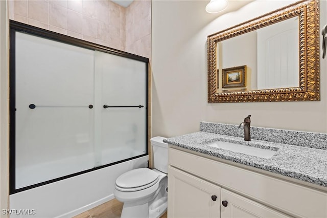 9435 Night Heron Ln, Naples, FL 34120 - bathroom with toilet, vanity, and enclosed tub / shower combo