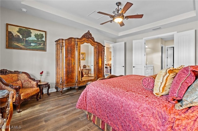 9435 Night Heron Ln, Naples, FL 34120 - bedroom with a raised ceiling, baseboards, visible vents, ceiling fan, and dark wood-style flooring