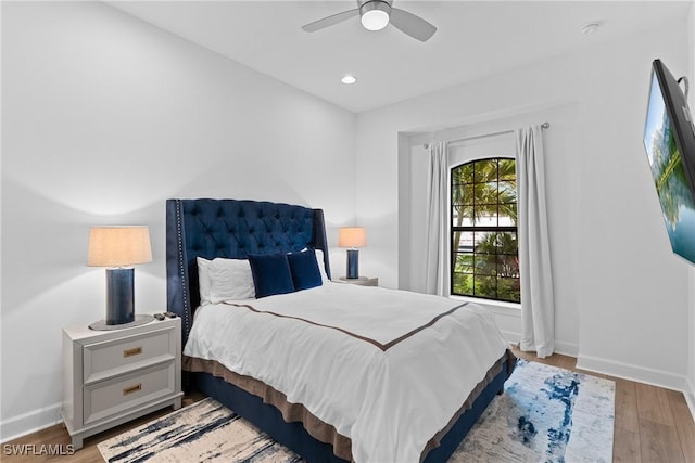 bedroom with baseboards, recessed lighting, wood finished floors, and a ceiling fan