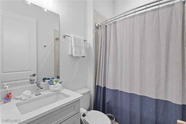 full bath featuring vanity, toilet, and curtained shower