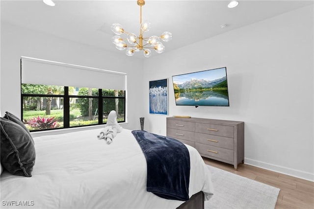 9336 Montelanico Loop, Naples, FL 34119 - bedroom featuring light wood-type flooring, a chandelier, recessed lighting, and baseboards