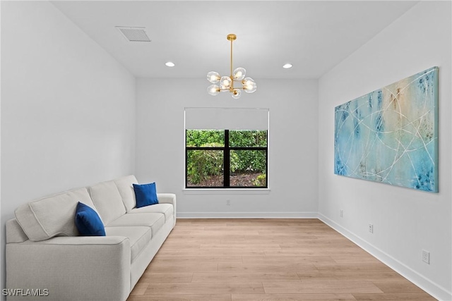 unfurnished room with recessed lighting, an inviting chandelier, visible vents, and light wood-style floors