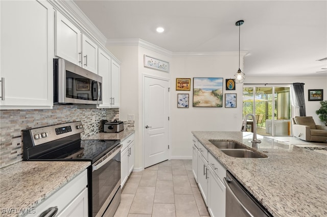 3657 Crimson Ln, Fort Myers, FL 33916 - kitchen with stainless steel appliances, a sink, backsplash, white cabinets, and ornamental molding