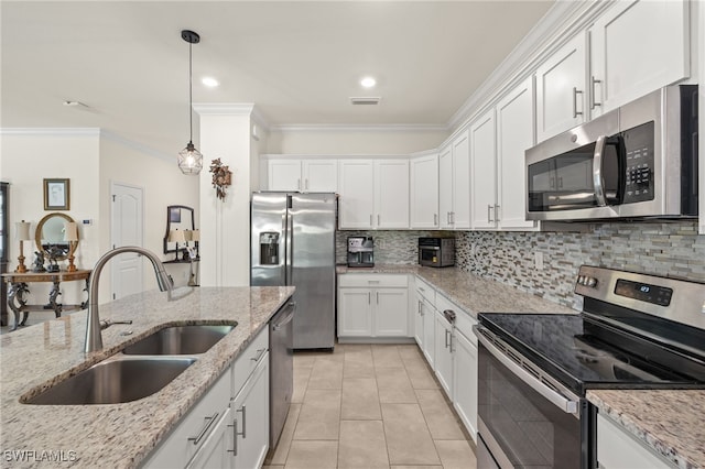 3657 Crimson Ln, Fort Myers, FL 33916 - kitchen featuring stainless steel appliances, a sink, crown molding, white cabinetry, and tasteful backsplash