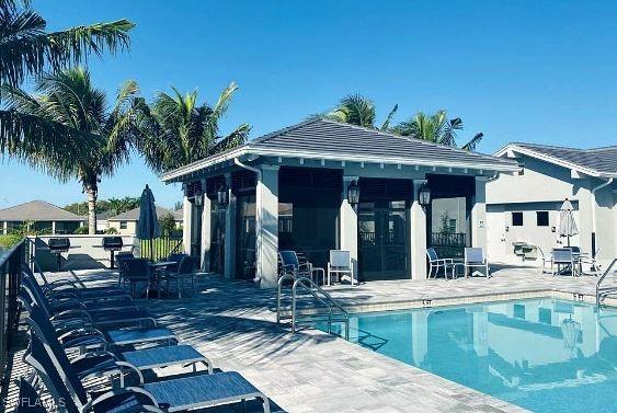 3657 Crimson Ln, Fort Myers, FL 33916 - community pool with a patio and an outdoor structure
