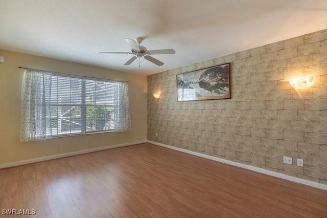 7857 Umberto Ct, Naples, FL 34114 - spare room with wood finished floors, baseboards, and a ceiling fan