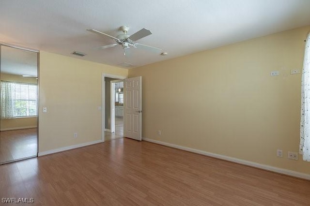 7857 Umberto Ct, Naples, FL 34114 - empty room featuring wood finished floors, visible vents, baseboards, and ceiling fan