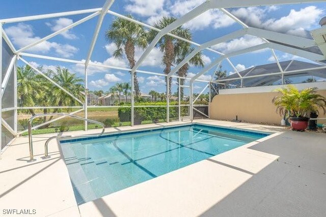 7857 Umberto Ct, Naples, FL 34114 - outdoor pool with a lanai and a patio area